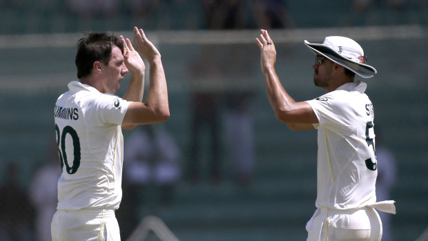 Pat Cummins celebrates a wicket with Mitchell Starc in the second Test. 