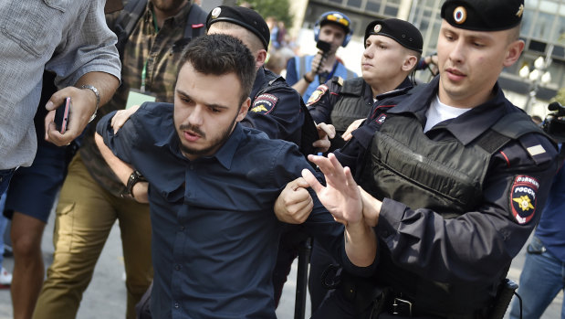 Police arrest a demonstrator during a rally protesting retirement age hikes in Moscow, Russia.