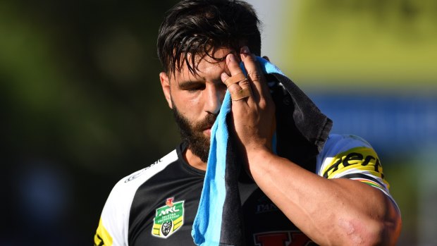 Lucky: Josh Mansour leaves the field after sustaining a serious facial injury against Gold Coast Titans