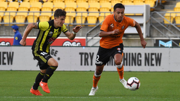 Dane Ingham of the Brisbane Roar  is chased by Louis Fenton of the Phoenix during the round 9 A-League match between Wellington and Brisbane at Westpac Stadium in Wellington, New Zealand.