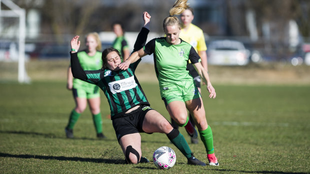 United's Hayley Taylor Young dodges a slide tackle.