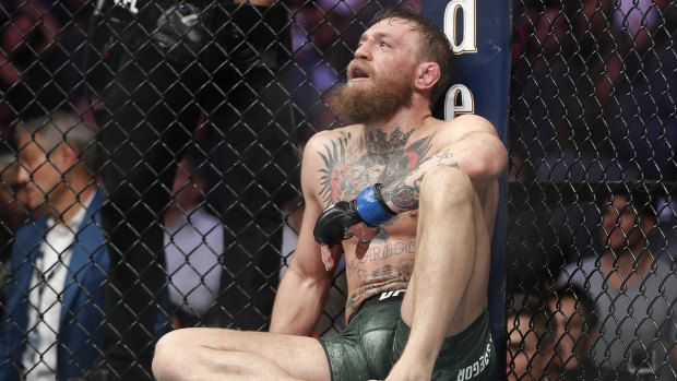 McGregor slumps against the cage after his defeat to Khabib in October - his last UFC fight.