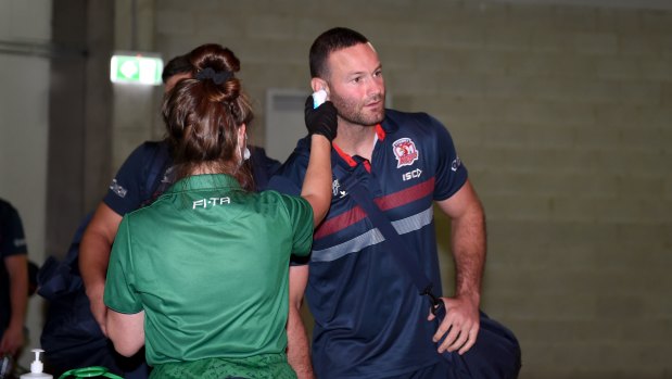 Roosters captain Boyd Cordner has his temperature taken before the clash with the Broncos. 