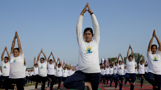 Indian paramilitary soldiers perform yoga on International Yoga Day at a base camp in Humhama, India-controlled Kashmir.