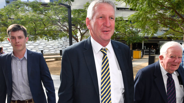 Denis Wagner (second from left) and his father Henry (right) arriving at the Supreme Court in Brisbane on Wednesday.