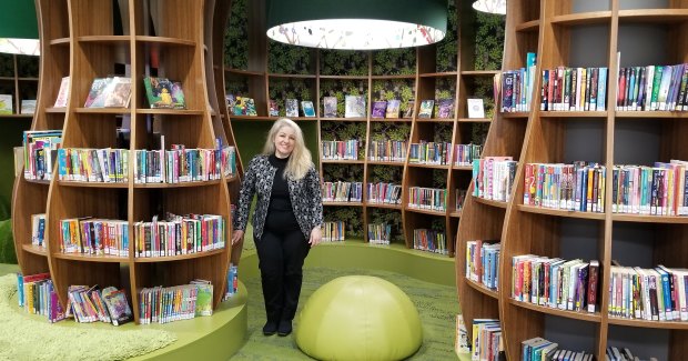 Specialist library designer Cecilia Kugler surrounded by her work at Bayside Library Rockdale.