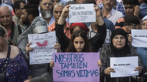 A girl holds a banner that reads: "We are also Victims" during a protest by the Muslim community condemning a jihadist terror attack in Barcelona, Spain, in 2017.
