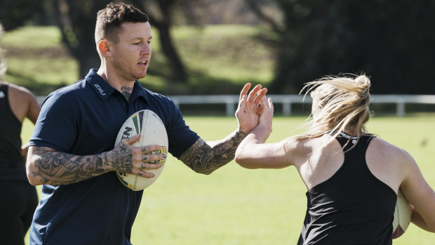 Mentor: Todd Carney conducts sprint training clinics with Roger Fabri at Centennial Park. 