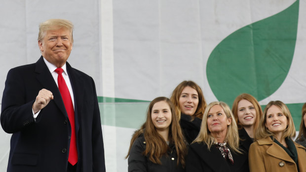 US President Donald Trump is watched by pro-life campaigners on stage at the March for Life in Washington on Friday.