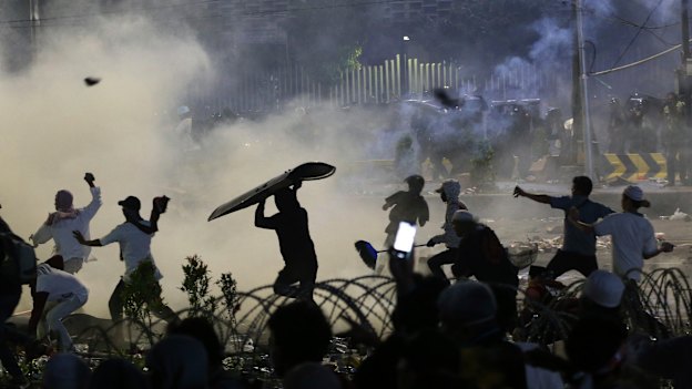 Rocks, riot shields and tear gas: central Jakarta on Wednesday night.