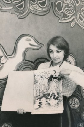 Mirka Mora hold up 'Mirka's Colouring Book No. One', 1970.