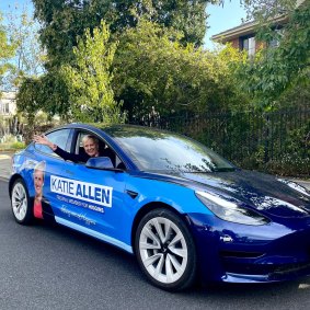 Katie Allen in her Tesla, specially branded for the campaign.