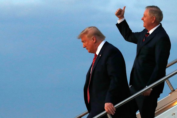 President Donald Trump and Lindsey Graham exit Air Force One as they arrive in North Charleston for a 2020 campaign rally. 