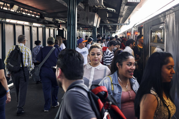 Commuters board the subway in New York, which still requires masks on trains and indoor stations. 