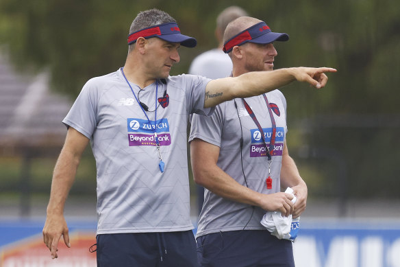 Demons assistant Adem Yze (left) will take charge this weekend after coach Simon Goodwin tested positive for COVID-19.