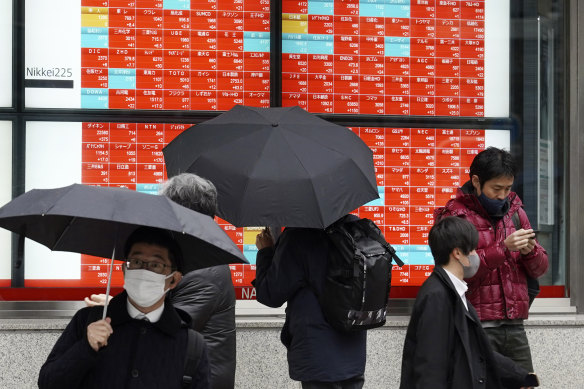 An electronic stock board at a Tokyo securities firm showing Japan’s Nikkei 225 index on January 24.