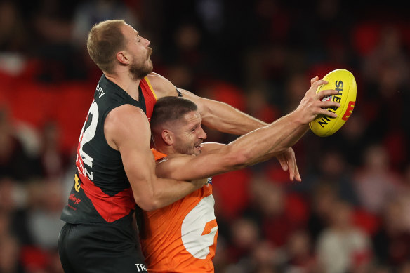 Essendon defender Ben McKay and Giants forward Jesse Hogan battle it out.