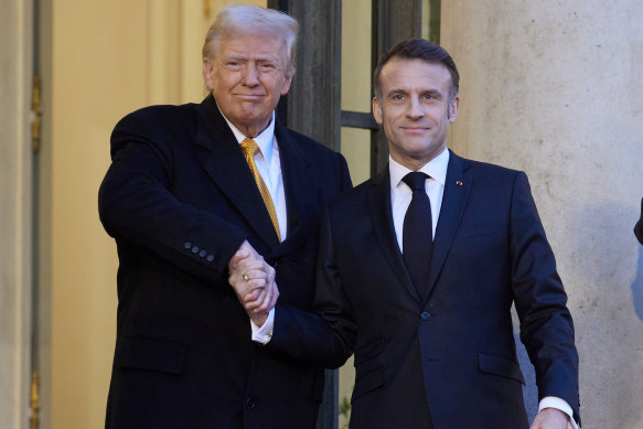 Paris rematch: Trump and Macron shake hands at the Elysee Palace on Saturday.