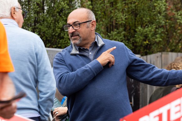 Labor MP Peter Khalil talking to voters at a pre-polling station.