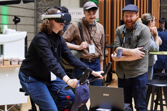 Kovarch (right) demonstrates his Pedal Rebel VR game at Play Now.