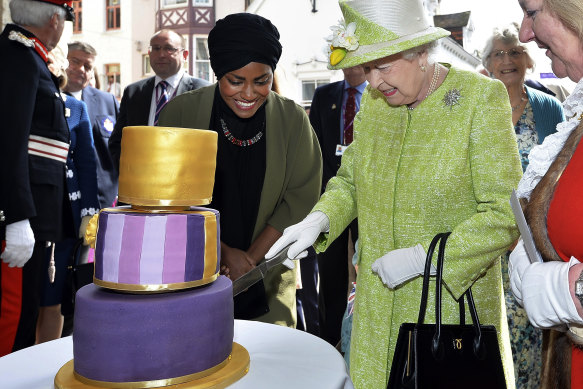 The Queen cuts a cake marking her 90th birthday in 2016.