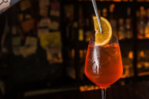 Bartender Pavlo Lavrykhin, 29, adds orange to the Aperol Spritz cocktail at the Squat 17B bar using Luxardo Aperitivo now instead of Aperol by Campari Group in Kyiv, Ukraine.