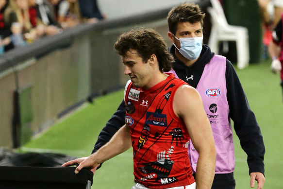 Andrew McGrath leaves the field injured in round 12. 