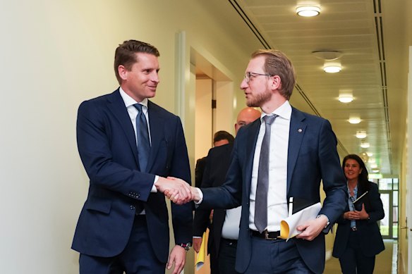 Andrew Hastie and James Paterson shake hands after the meeting. 