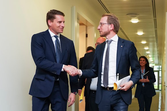 Andrew Hastie and James Paterson  shake hands after the Wednesday meeting.