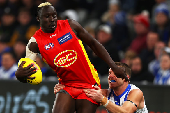 Gold Coast’s Mabior Chol is tackled.