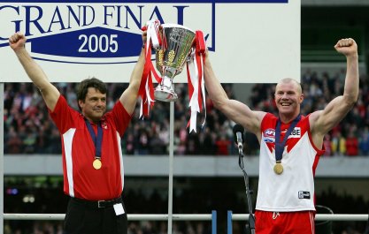 Paul Roos, as Swans coach, holds the 2005 premiership cup aloft with Barry Hall. 