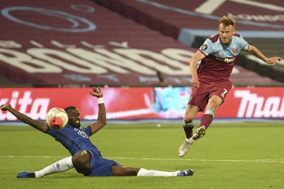 West Ham's Andriy Yarmolenko, right shoots and scores his side's third goal past Chelsea's Antonio Rudiger during the English Premier League soccer match between West Ham United and Chelsea at the London Stadium stadium in London.