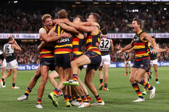 Celebrations: The Crows rush to Jordan Dawson.