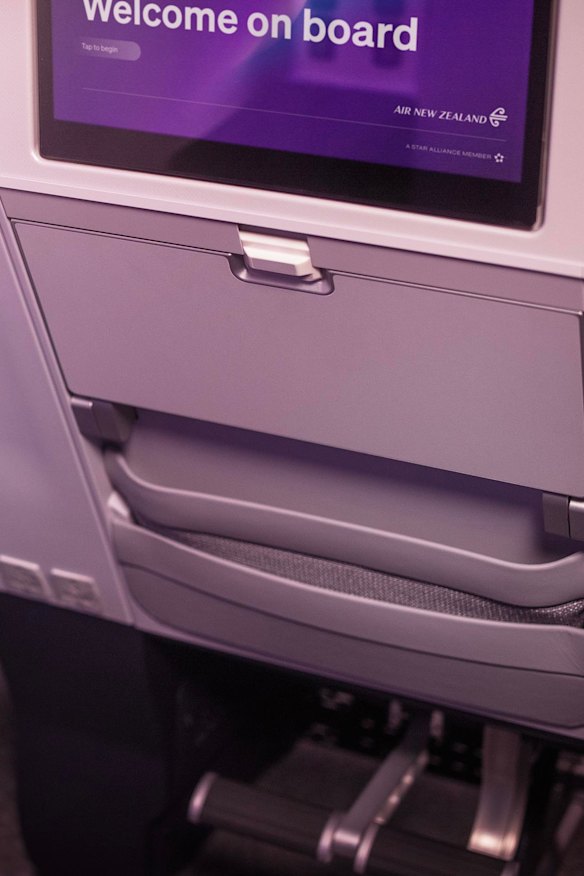 The tray table can make a half-fold and has a slot for a digital device; if there’s a seat in front, there are footrests below.