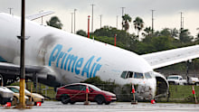 The Amazon cargo plane sits at Miami International Airport after overshooting a runway and killing five people.