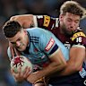 Nathan Cleary is wrapped up by Maroons forward Pat Carrigan.