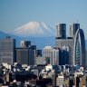 Mount Fuji and the Shinjuku skyline seen from an observation deck in Tokyo, Japan.