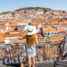 Young woman tourist enjoying beautiful cityscape top view on the old town during the sunny day in Lisbon city, Portugal iStock image for Traveller. Re-use permitted.
