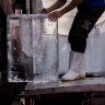 A man unloads blocks of ice from a truck during a heatwave in Bangkok.