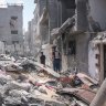 Palestinians inspect the rubble of a building after an Israeli airstrike in central Gaza last month.