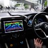 A driver takes their hands off the wheel of a Nissan Leaf electric vehicle equipped with autonomous driving technology during a test ride in the Yokohama, Japan.