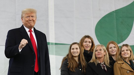 US President Donald Trump is watched by pro-life campaigners on stage at the March for Life in Washington on Friday.