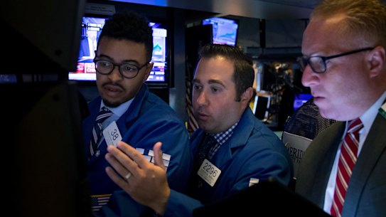 Traders on the floor of the New York Stock Exchange on Monday. China's drastic retaliation in the trade war has sent financial markets reeling.