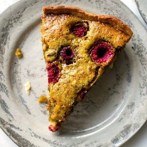 A slice of pistachio and raspberry tart.