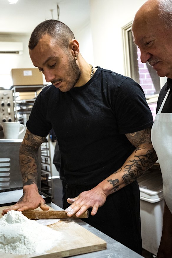 Cavallaro and his son Andrew roll cannoli.