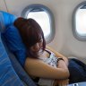 Passenger sleeping on a flight. 