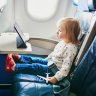 Adorable little toddler girl traveling by plane. Small child sitting by aircraft window and using a digital tablet during the flight. Traveling abroad with kids. Unaccompanied minor concept iStock image for Traveller. Re-use permitted.