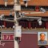 Security cameras in front of a portrait of former Chinese leader Mao Zedong at Tiananmen Square.