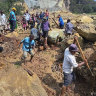 Villagers search through a landslide in Pogera village, in the Highlands of Papua New Guinea.