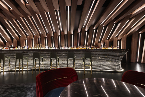 Curious features an undulating ceiling of brightly lit timber beams.